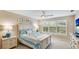 Bright bedroom featuring a comfortable bed with blue accents, coastal decor, and soft, neutral wall color at 2306 64Th W St # 17, Bradenton, FL 34209