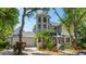 Charming gray home with a tower, lush landscaping, brick driveway, and a two-car garage at 2306 64Th W St # 17, Bradenton, FL 34209