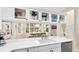 Modern kitchen features white cabinetry, quartz countertops, and a view into the dining area at 2306 64Th W St # 17, Bradenton, FL 34209