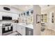 Bright kitchen boasts white cabinets, stainless steel appliances, and seamless access to the breakfast nook at 2306 64Th W St # 17, Bradenton, FL 34209