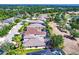 Aerial view of homes in a lush, landscaped neighborhood with lake views and mature trees at 235 Dahlia Ct, Bradenton, FL 34212