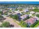 Aerial view of homes in a suburban neighborhood with a lake and well-maintained landscaping at 235 Dahlia Ct, Bradenton, FL 34212