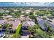 Aerial view of a landscaped property with a well-maintained yard and mature trees in a suburban neighborhood at 235 Dahlia Ct, Bradenton, FL 34212