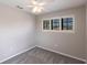 Bright bedroom featuring neutral walls, a ceiling fan, and a large window with outside views at 235 Dahlia Ct, Bradenton, FL 34212