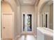 Bright foyer featuring arched doorways, tile flooring, and large mirrors creating an open and inviting space at 235 Dahlia Ct, Bradenton, FL 34212