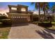 Beautiful two-story home featuring a two-car garage and a paved driveway, set against a colorful sky at 235 Dahlia Ct, Bradenton, FL 34212