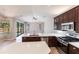 Modern kitchen with stainless steel appliances, white quartz countertops, island, and backyard pool views at 235 Dahlia Ct, Bradenton, FL 34212
