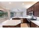 Modern kitchen with stainless steel appliances, white quartz countertops, island, and backyard pool views at 235 Dahlia Ct, Bradenton, FL 34212