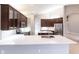 Open kitchen featuring a large island, dark wood cabinets, stainless steel appliances, and a view of the dining area at 235 Dahlia Ct, Bradenton, FL 34212