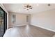 Bright, spacious living room with wood flooring, a ceiling fan, and sliding glass doors at 235 Dahlia Ct, Bradenton, FL 34212