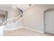 An inviting living space featuring tile flooring and a staircase with white wood risers and banister at 235 Dahlia Ct, Bradenton, FL 34212
