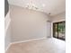 Inviting living space boasts tile flooring, modern chandelier, and access to the screened lanai and pool at 235 Dahlia Ct, Bradenton, FL 34212