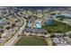 Overhead view of the community pool, tennis courts, clubhouse, parking, and lake at 2407 New Haven Cir, Sun City Center, FL 33573