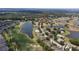 Birds-eye of neighborhood with community ponds, well-manicured golf course, and mature trees at 2407 New Haven Cir, Sun City Center, FL 33573
