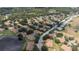 Overhead shot showcasing the neighborhood's layout, trees, and nearby golf course at 2407 New Haven Cir, Sun City Center, FL 33573