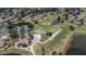 Aerial shot of the golf course, ponds, clubhouse, parking area, and surrounding neighborhood at 2407 New Haven Cir, Sun City Center, FL 33573