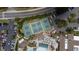 An overhead picture of tennis courts, pool-side seating, a nearby parking lot, and clubhouse at 2407 New Haven Cir, Sun City Center, FL 33573