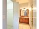 Bathroom featuring a wooden vanity and tiled floors, providing a warm and inviting atmosphere at 2407 New Haven Cir, Sun City Center, FL 33573