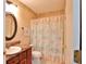 Charming bathroom with decorative wallpaper border, vanity and shower/tub combination at 2407 New Haven Cir, Sun City Center, FL 33573