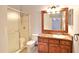 Bathroom with granite countertops, vanity, tiled floors, toilet and glass shower showcasing a neutral aesthetic at 2407 New Haven Cir, Sun City Center, FL 33573