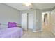 Cozy bedroom with neutral tones, tile flooring, closet and a ceiling fan for added comfort at 2407 New Haven Cir, Sun City Center, FL 33573