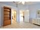 Spacious bedroom with tile floors, built-in shelving, ensuite bathroom, and bright natural light at 2407 New Haven Cir, Sun City Center, FL 33573
