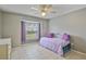 Comfortable bedroom featuring tile flooring, built in closet and natural lighting from the window at 2407 New Haven Cir, Sun City Center, FL 33573