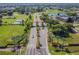 Aerial view of the gated community entrance adorned with palm trees and manicured landscaping at 2407 New Haven Cir, Sun City Center, FL 33573