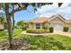 Charming single-story home featuring a well-manicured lawn, mature landscaping, and inviting curb appeal at 2407 New Haven Cir, Sun City Center, FL 33573