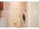 Practical laundry room with modern appliances, tiled floors, and convenient outdoor access at 2407 New Haven Cir, Sun City Center, FL 33573
