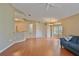 Open-concept living area with hardwood floors, modern lighting, and a comfortable blue sofa at 2407 New Haven Cir, Sun City Center, FL 33573
