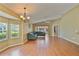 Inviting living room with hardwood floors, large windows, and a comfortable blue sectional sofa at 2407 New Haven Cir, Sun City Center, FL 33573