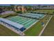 Aerial view of well-maintained shuffleboard courts with covered seating areas for residents to enjoy the outdoors at 2407 New Haven Cir, Sun City Center, FL 33573