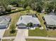 Charming single Gathering home featuring a spacious lawn, attached garage, and screened-in backyard pool at 245 Woodingham Trl, Venice, FL 34292