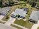 Charming single Gathering home featuring a spacious lawn, attached garage, and screened-in backyard pool at 245 Woodingham Trl, Venice, FL 34292