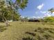Expansive backyard with lush green grass and mature trees creating a private oasis at 245 Woodingham Trl, Venice, FL 34292