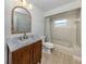 Bright bathroom features a modern vanity, bathtub with shower, and neutral color palette at 245 Woodingham Trl, Venice, FL 34292
