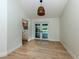 Dining room with wood floors and a view of the pool through sliding glass doors at 245 Woodingham Trl, Venice, FL 34292