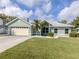 Inviting single-story home featuring a two-car garage, neat landscaping, and a well-manicured front yard at 245 Woodingham Trl, Venice, FL 34292