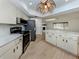 Spacious kitchen featuring white cabinets, stainless steel appliances, and ample counter space at 245 Woodingham Trl, Venice, FL 34292