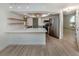 Charming kitchen features stainless steel appliances, a breakfast bar, and updated light fixtures at 245 Woodingham Trl, Venice, FL 34292