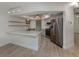 Bright kitchen with white cabinets, stainless steel appliances, and a unique light fixture at 245 Woodingham Trl, Venice, FL 34292