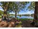 Picturesque lake view with lush trees, a bench, and a serene atmosphere at 245 Woodingham Trl, Venice, FL 34292