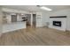 Open-concept living space connecting the kitchen and living room with wood flooring at 245 Woodingham Trl, Venice, FL 34292