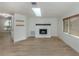 Bright living room with fireplace and wood flooring, leading to an adjacent room at 245 Woodingham Trl, Venice, FL 34292