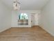 Bright living room boasts wood floors, arched window, and elegant lighting at 245 Woodingham Trl, Venice, FL 34292