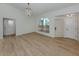 Living room features wood floors, natural light, and elegant light fixtures at 245 Woodingham Trl, Venice, FL 34292