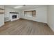 Spacious living room featuring a fireplace, a large window, and wood flooring at 245 Woodingham Trl, Venice, FL 34292