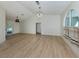 Large living room with vaulted ceiling, wood floors, and views of the backyard pool at 245 Woodingham Trl, Venice, FL 34292