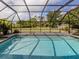 Sparkling in-ground pool enclosed by a screen, offering a private and refreshing outdoor space at 245 Woodingham Trl, Venice, FL 34292